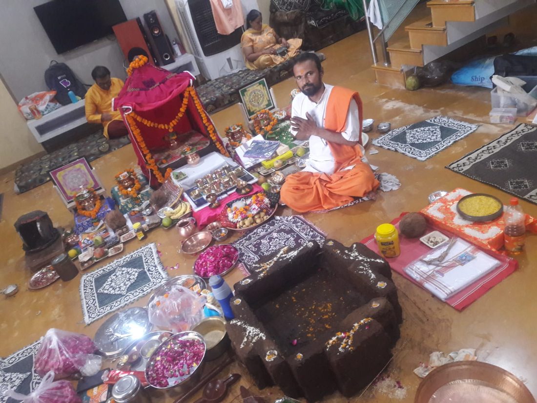 Havan kund and a large puja arrangement in a home